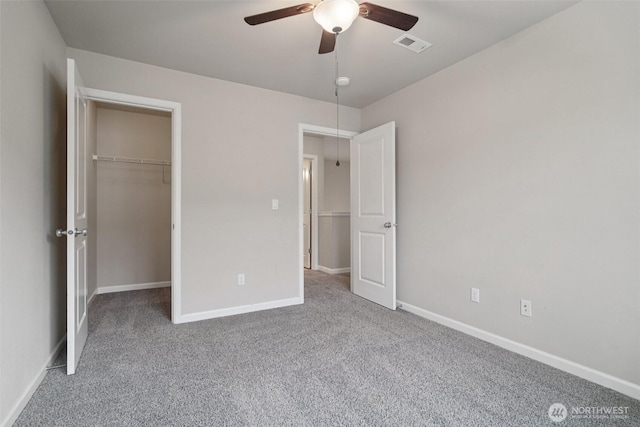 14403 Lockwood Ln SE, Yelm, WA 98597 - unfurnished bedroom with carpet floors, a spacious closet, a closet, and ceiling fan