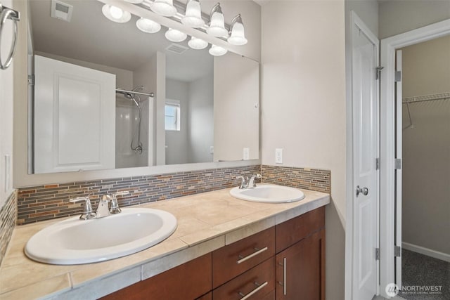 14403 Lockwood Ln SE, Yelm, WA 98597 - bathroom with decorative backsplash, double vanity, a shower, and a spacious closet