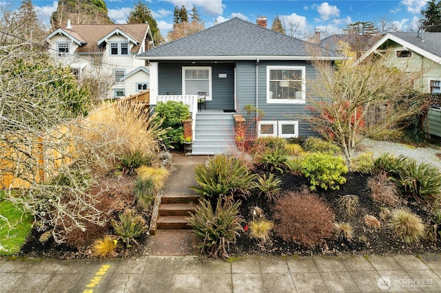 3232 37th Ave S, Seattle, WA 98144 - view of front of property featuring stairway, covered porch, a chimney, and a shingled roof