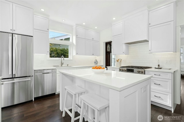 3232 37th Ave S, Seattle, WA 98144 - kitchen with stainless steel appliances, white cabinets, light countertops, dark wood finished floors, and a center island