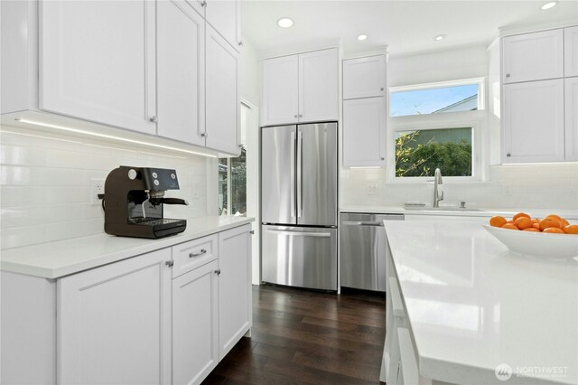 3232 37th Ave S, Seattle, WA 98144 - kitchen featuring stainless steel appliances, white cabinets, decorative backsplash, light countertops, and dark wood-style floors