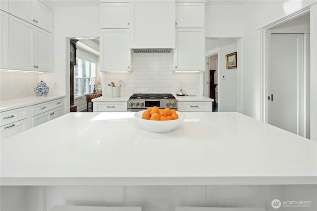 3232 37th Ave S, Seattle, WA 98144 - kitchen with stainless steel gas range, white cabinets, backsplash, and light countertops