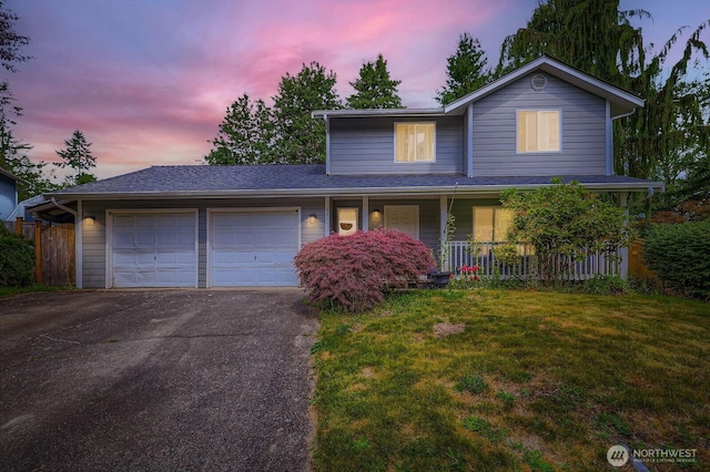 9806 6th Pl SE, Lake Stevens, WA 98258 - traditional-style home featuring an attached garage, asphalt driveway, a lawn, and covered porch