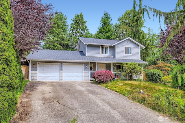 9806 6th Pl SE, Lake Stevens, WA 98258 - traditional-style house featuring an attached garage, covered porch, asphalt driveway, and roof with shingles