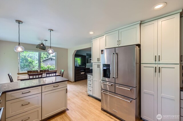 9806 6th Pl SE, Lake Stevens, WA 98258 - kitchen featuring high end refrigerator, dark stone counters, light wood-style flooring, recessed lighting, and decorative light fixtures