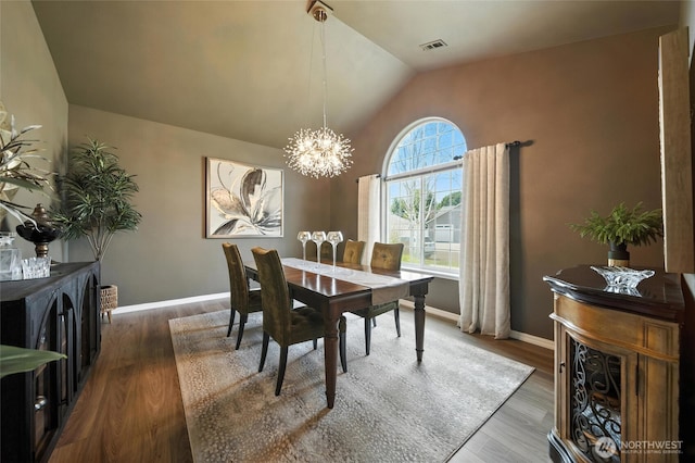 52 Whistling Duck Rd, Walla Walla, WA 99362 - dining space featuring a chandelier, lofted ceiling, and wood finished floors
