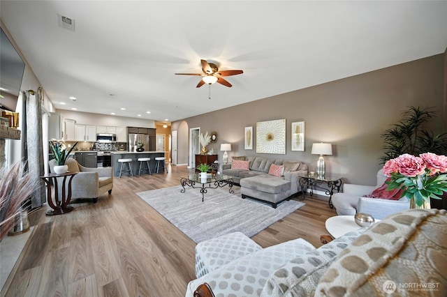52 Whistling Duck Rd, Walla Walla, WA 99362 - living room with ceiling fan, light wood-style flooring, recessed lighting, and arched walkways