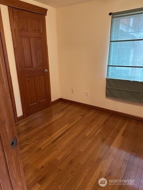 6829 Weedin Pl NE, Seattle, WA 98115 - empty room featuring wood finished floors and baseboards