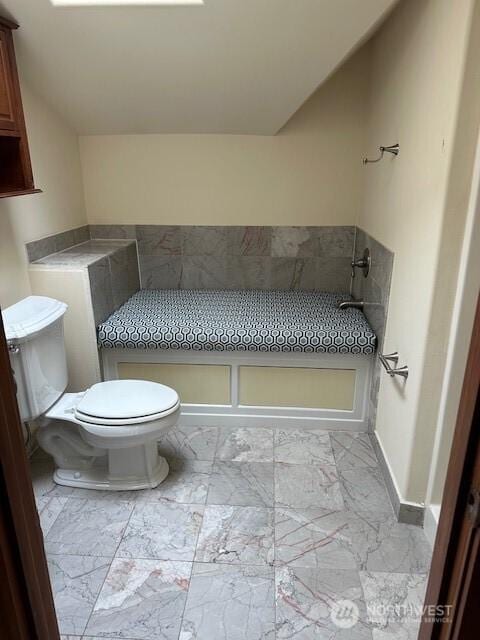 6829 Weedin Pl NE, Seattle, WA 98115 - bathroom with marble look tile flooring and vaulted ceiling
