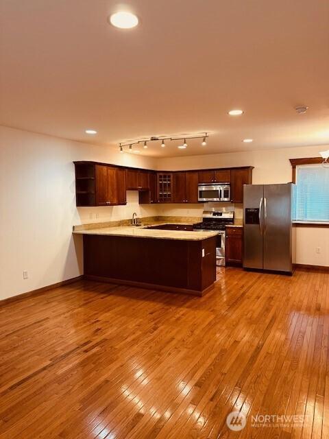 6829 Weedin Pl NE, Seattle, WA 98115 - kitchen with stainless steel appliances, a peninsula, hardwood / wood-style flooring, light countertops, and recessed lighting