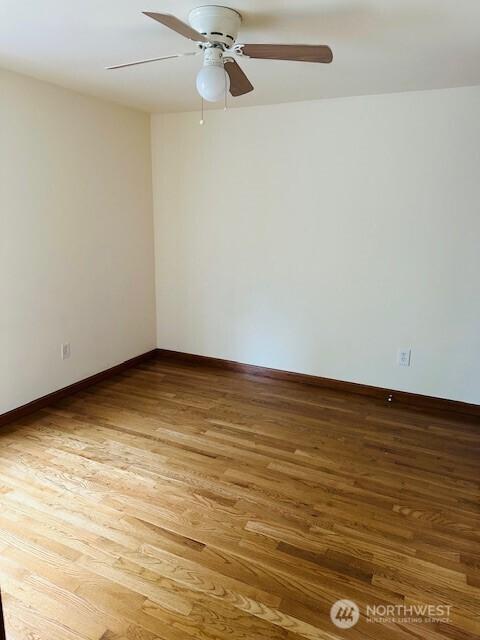 6829 Weedin Pl NE, Seattle, WA 98115 - spare room featuring wood finished floors and a ceiling fan