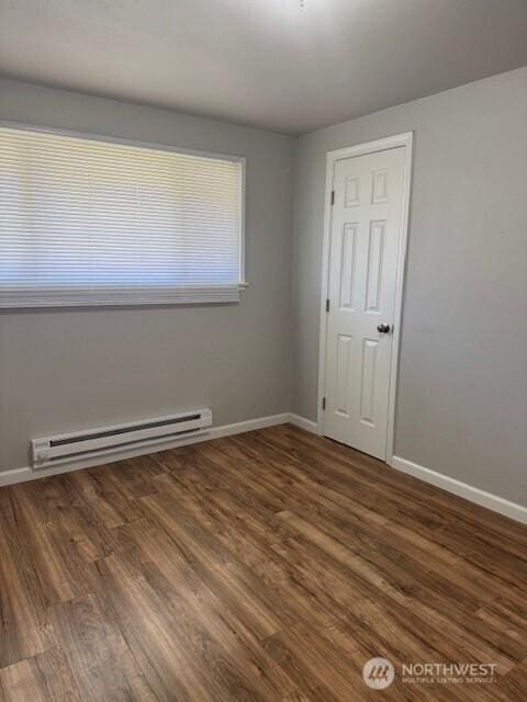 506 SW D St Unit 512, Ephrata, WA 98823 - spare room with a baseboard heating unit and wood finished floors
