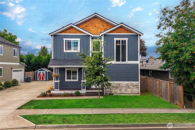 814 9th St SW, Puyallup, WA 98371 - craftsman house with a storage unit, board and batten siding, covered porch, concrete driveway, and stone siding