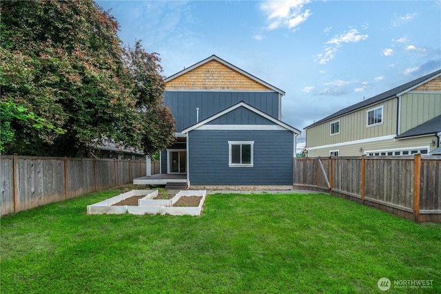 814 9th St SW, Puyallup, WA 98371 - back of house with a garden, a fenced backyard, and board and batten siding