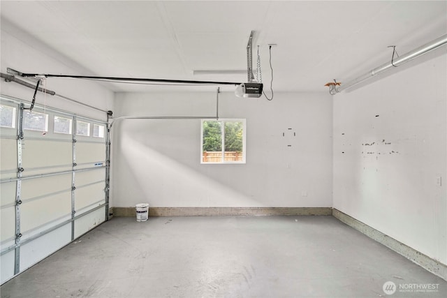 814 9th St SW, Puyallup, WA 98371 - garage featuring a garage door opener and baseboards