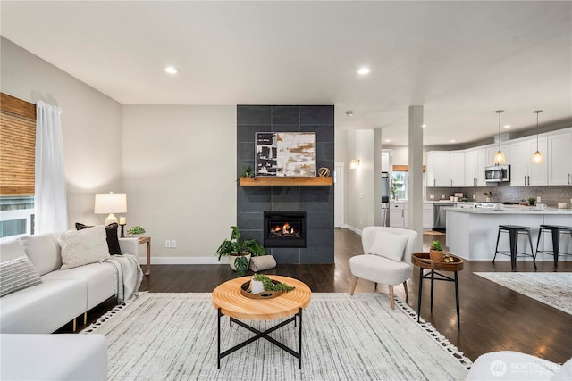814 9th St SW, Puyallup, WA 98371 - living area featuring dark wood finished floors, a tiled fireplace, and recessed lighting
