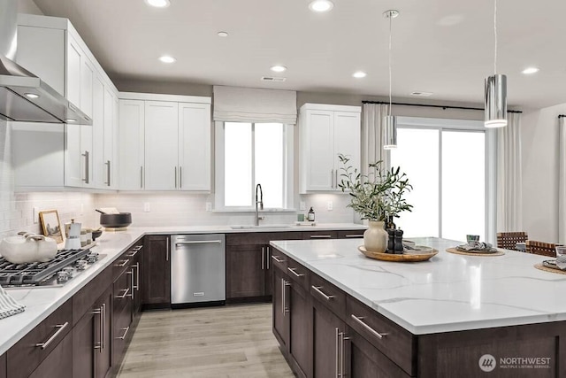 13212 164th Ave SE Unit 207, Renton, WA 98059 - kitchen with appliances with stainless steel finishes, wall chimney exhaust hood, white cabinetry, dark brown cabinetry, and recessed lighting