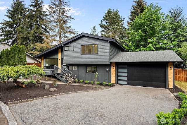 13652 99th Ave NE, Kirkland, WA 98034 - tri-level home with asphalt driveway, an attached garage, and roof with shingles