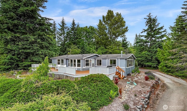 2366 Northshore Rd, Bellingham, WA 98226 - manufactured / mobile home featuring a wooden deck, driveway, and roof with shingles
