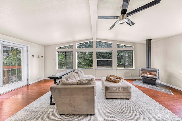 2366 Northshore Rd, Bellingham, WA 98226 - living room with wood finished floors, healthy amount of natural light, ceiling fan, a wood stove, and a textured ceiling
