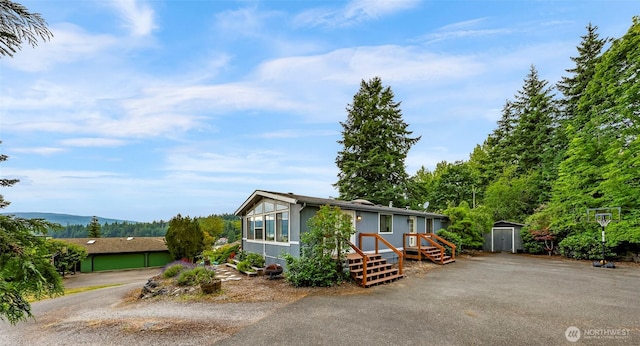 2366 Northshore Rd, Bellingham, WA 98226 - view of front of house with a storage shed and asphalt driveway