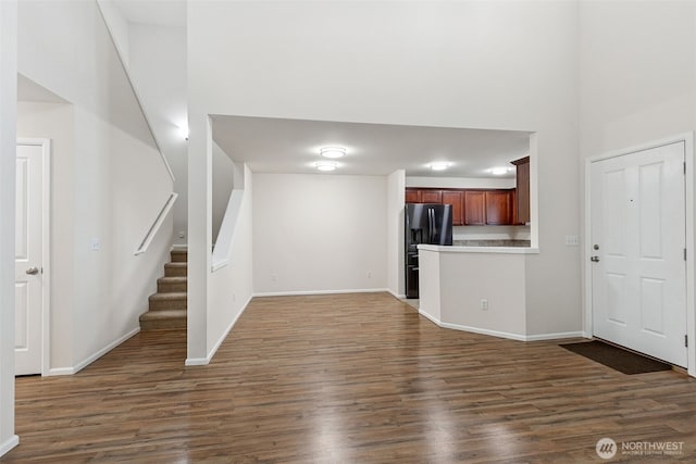 6540 Indiana St SE, Olympia, WA 98513 - unfurnished living room with dark wood finished floors, stairs, and a high ceiling