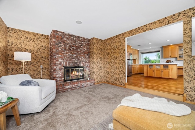 347 W King Tut Rd, Bellingham, WA 98226 - living room featuring wallpapered walls, a fireplace, light wood-style floors, light carpet, and recessed lighting