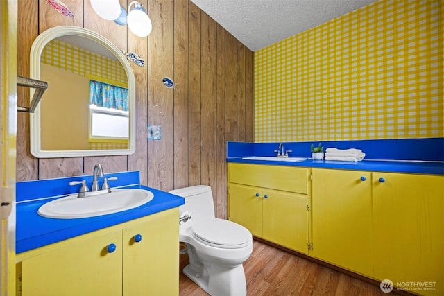 347 W King Tut Rd, Bellingham, WA 98226 - bathroom with vanity, a textured ceiling, wallpapered walls, and wood finished floors