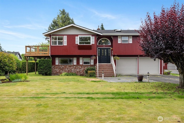 347 W King Tut Rd, Bellingham, WA 98226 - bi-level home featuring asphalt driveway, an attached garage, a front lawn, brick siding, and a deck