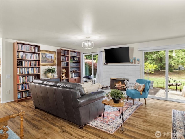 3300 Carpenter Rd SE Unit 49, Lacey, WA 98503 - living room with a fireplace, a chandelier, and wood finished floors
