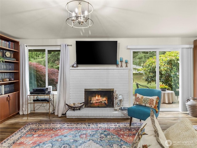 3300 Carpenter Rd SE Unit 49, Lacey, WA 98503 - living area with a brick fireplace, a chandelier, and wood finished floors