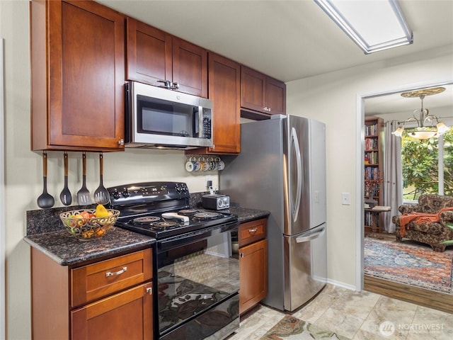 3300 Carpenter Rd SE Unit 49, Lacey, WA 98503 - kitchen with appliances with stainless steel finishes, dark stone countertops, a chandelier, and brown cabinetry