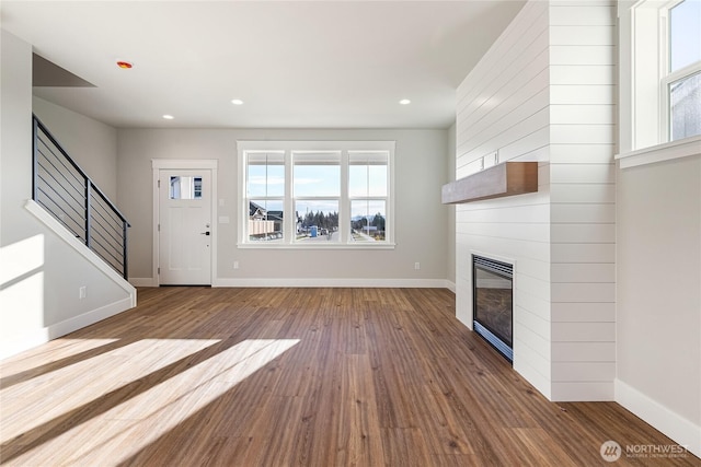 2630LOT12 Sievers Way, Ferndale, WA 98248 - unfurnished living room featuring wood finished floors, a fireplace, stairway, and recessed lighting