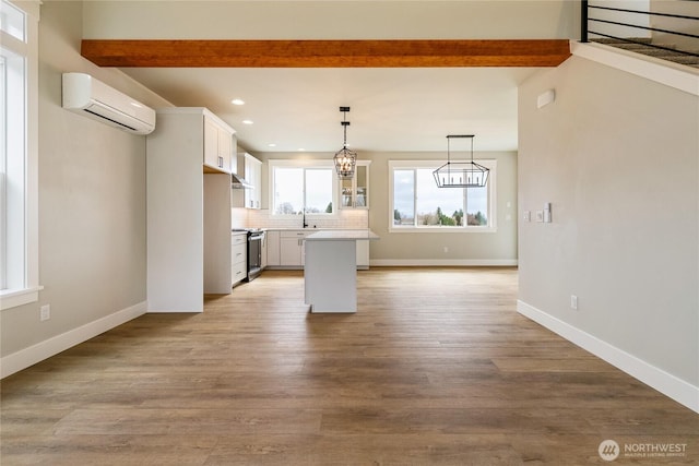 2632LOT13 Sievers Way, Ferndale, WA 98248 - kitchen with a wall mounted AC, stainless steel electric range, recessed lighting, beamed ceiling, and light countertops