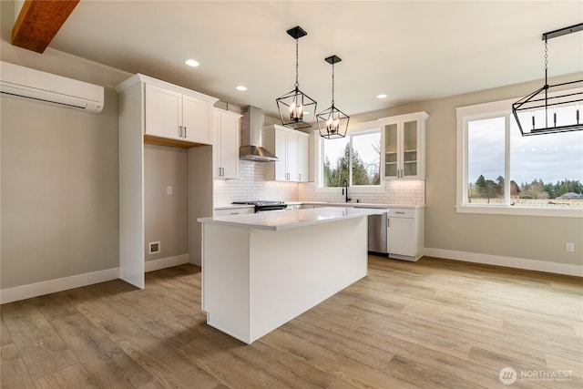 2632LOT13 Sievers Way, Ferndale, WA 98248 - kitchen featuring wall chimney exhaust hood, a wall mounted AC, stainless steel dishwasher, decorative backsplash, and white cabinetry