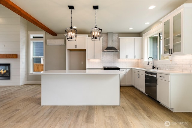 2632LOT13 Sievers Way, Ferndale, WA 98248 - kitchen with wall chimney range hood, stainless steel dishwasher, light wood-type flooring, backsplash, and a wall mounted AC