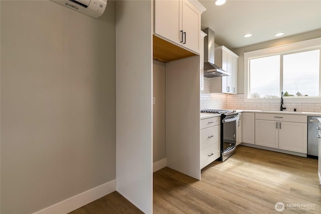 2632LOT13 Sievers Way, Ferndale, WA 98248 - kitchen with wall chimney range hood, stainless steel range, backsplash, light wood-style flooring, and light countertops