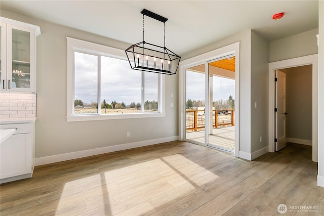 2632LOT13 Sievers Way, Ferndale, WA 98248 - unfurnished dining area with healthy amount of natural light, a chandelier, and light wood-style floors