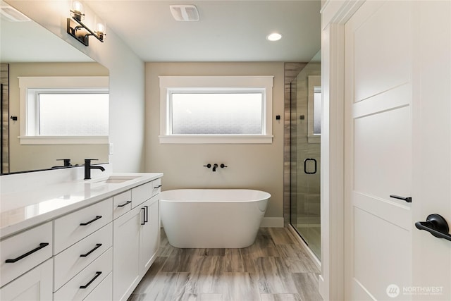 2632LOT13 Sievers Way, Ferndale, WA 98248 - full bath with vanity, plenty of natural light, a soaking tub, a stall shower, and recessed lighting