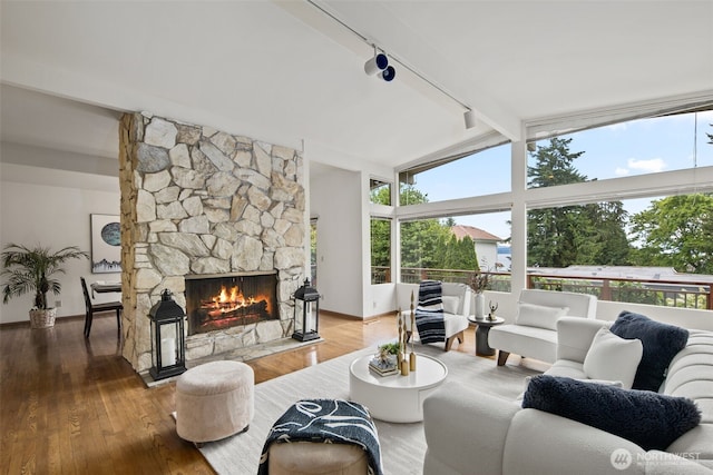 3015 44th Ave W, Seattle, WA 98199 - living room featuring rail lighting, a fireplace, and wood finished floors