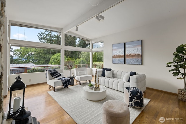 3015 44th Ave W, Seattle, WA 98199 - living room featuring healthy amount of natural light, track lighting, and wood finished floors
