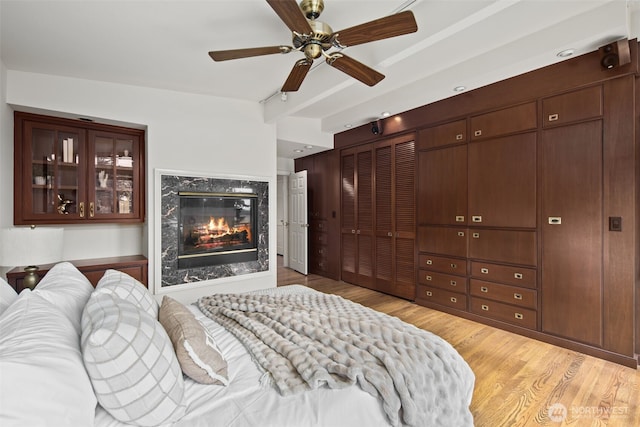 3015 44th Ave W, Seattle, WA 98199 - bedroom featuring light wood-type flooring, a high end fireplace, and ceiling fan