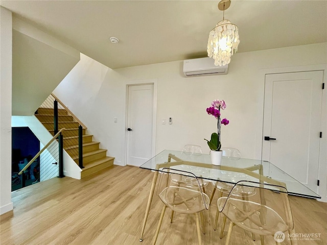 746 N 88th St, Seattle, WA 98103 - unfurnished dining area with a wall unit AC, wood finished floors, stairs, and a chandelier