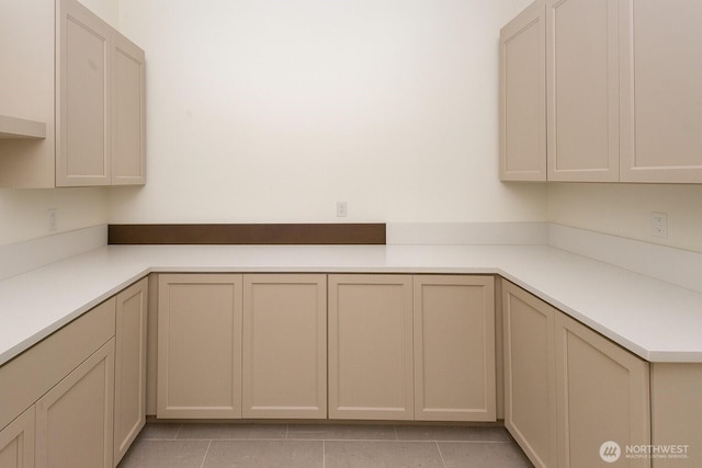 12107 Mundy Loss Rd E, Buckley, WA 98321 - kitchen with light tile patterned floors, light countertops, and cream cabinets