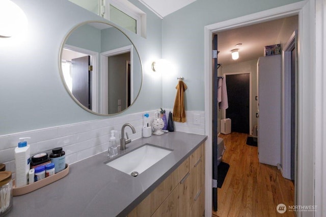 133 Thomas St NW, Olympia, WA 98502 - bathroom with wood finished floors, decorative backsplash, and vanity
