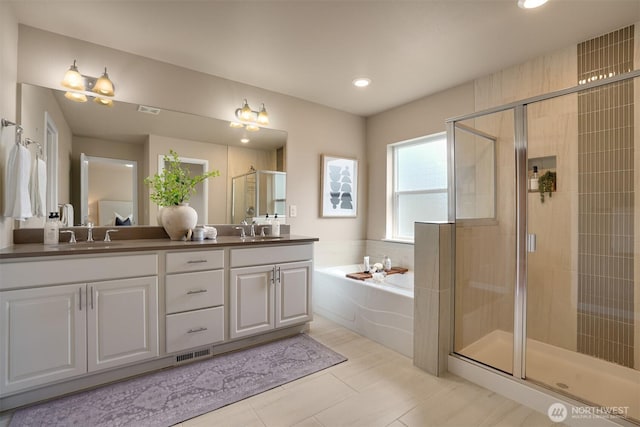 4418 233rd Pl SE, Bothell, WA 98021 - bathroom featuring a garden tub, double vanity, a shower stall, recessed lighting, and tile patterned floors