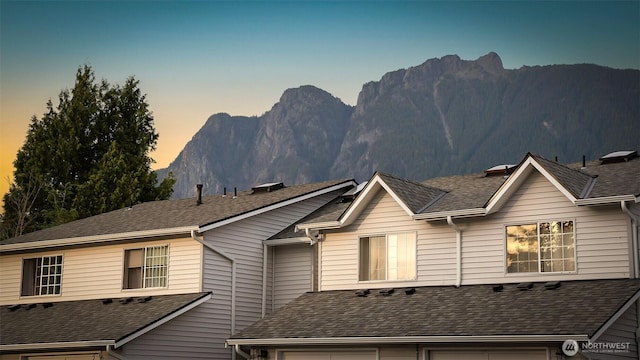 315E Park St Unit A22, North Bend, WA 98045 - view of front of property featuring a garage, a mountain view, and roof with shingles