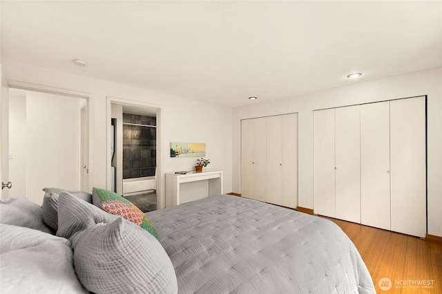 500 Aloha St Unit 202, Seattle, WA 98109 - bedroom with multiple closets, light wood finished floors, and recessed lighting