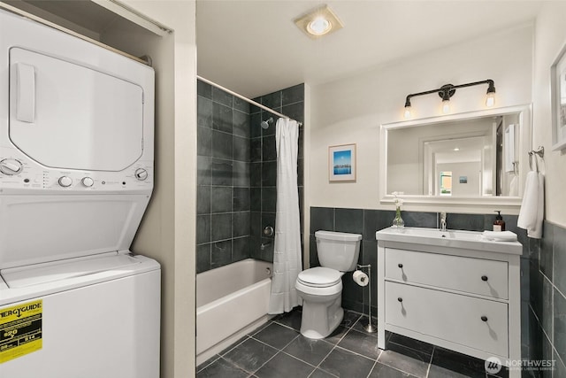 500 Aloha St Unit 202, Seattle, WA 98109 - bathroom featuring stacked washer / dryer, vanity, shower / tub combo with curtain, tile patterned floors, and a wainscoted wall