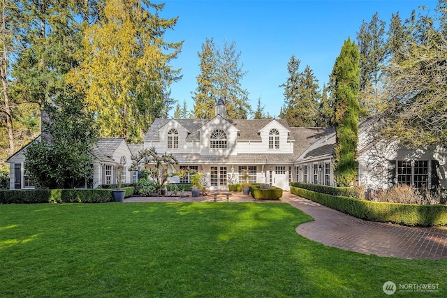 1135 Evergreen Point Rd, Medina, WA 98039 - new england style home with a front yard, a patio area, and french doors